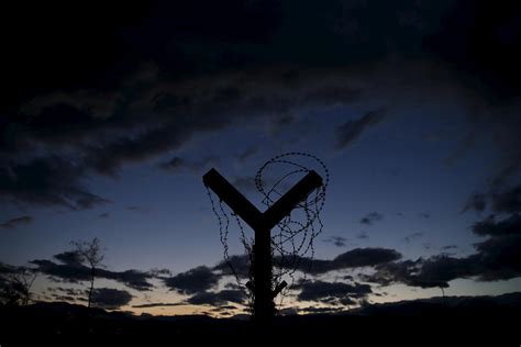 A Border Fence with Razor Wire Photograph by Marko Djurica - Pixels