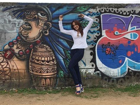 Could not resist posing in front of the graffiti that is so common all ...