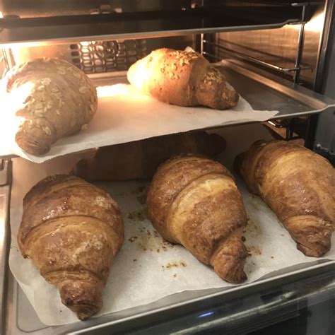 Breads And Pastries Sit In The Oven On Paper Under Them Ready To Be Baked