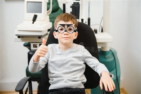 Cheerful Child Boy In Glasses Checks Eye Vision Pediatric