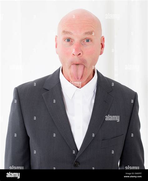 Bald Headed Man In A Suit Sticks Out His Tongue Stock Photo Alamy