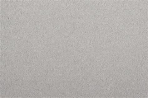 Free AI Image | A beige textured wallpaper with a metallic finish.