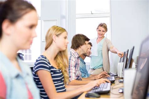 Computer Teacher Helping Students Stock Image Image Of Female