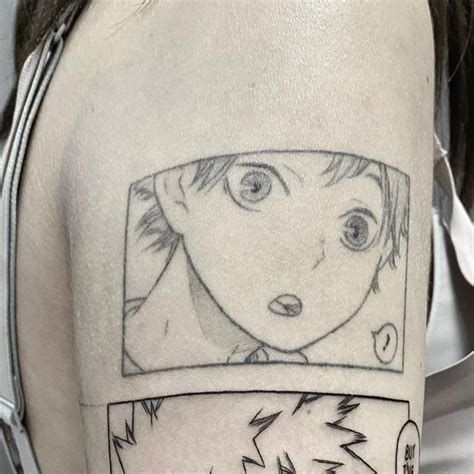 A Person With A Tattoo On Their Arm That Has An Image Of A Boy In The