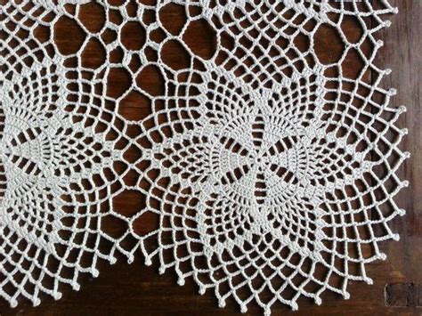 Two Crocheted Doily On A Wooden Surface