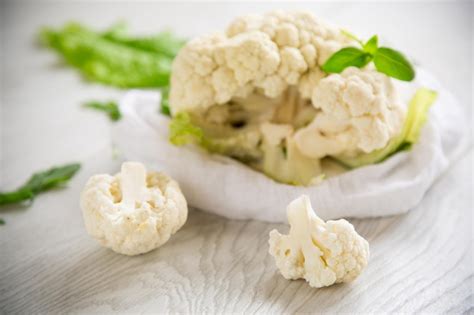 Premium Photo Inflorescences Of Small Cauliflower On A Light Wooden Table