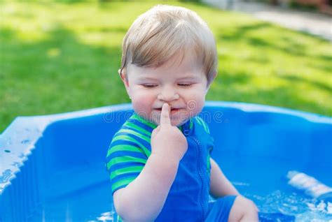 Adorable Blond Toddler Boy Having Fun With Water By Taking Bath Stock