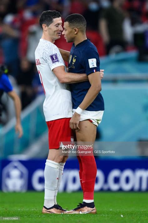 Robert Lewandowski Of Poland Embraces Kylian Mbappe Of France During