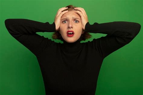 Jeune fille blonde inquiète gardant les mains sur la tête Photo Gratuite