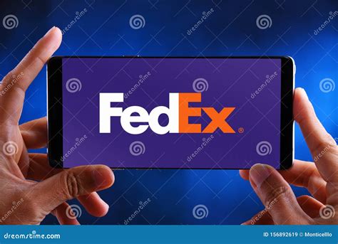 Hands Holding Smartphone Displaying Logo Of Fedex Editorial Stock Image