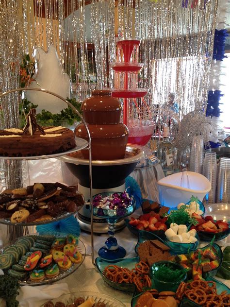 a table topped with lots of desserts and pastries next to a cake stand