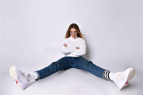 Blonde Teen Girl In Jeans Sweater Socks And Sneakers She Smiling