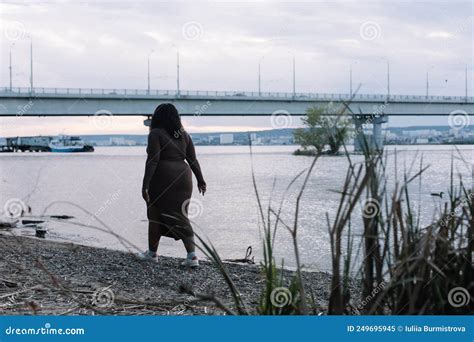 Curly Black Haired Serious Plump Afro American Multiracial Woman