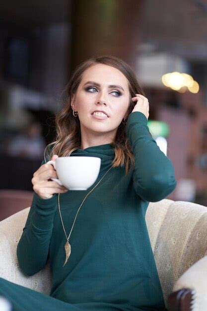 Premium Photo Portrait Of Smiling Young Woman Using Mobile Phone