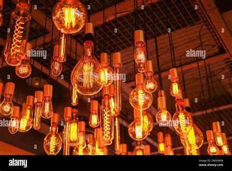 Various Styles Of Filament Light Bulb Hanging On The Ceiling Stock