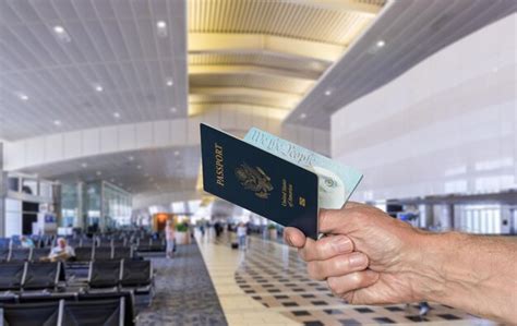 Premium Photo Cropped Image Of Hand Holding Passport In Airport