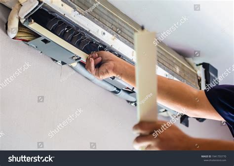 Air Conditioning Repair Repairman Fixing Air Shutterstock