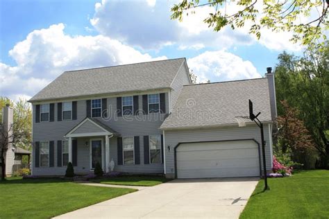 Beautiful Suburban House with Stunning Cloudscape Background