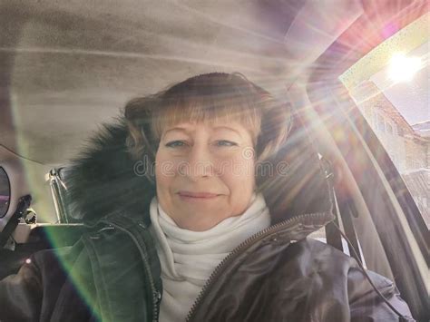 Middle Aged Woman In A Car Taking Selfie While Enjoying A Drive Female Mature Driver Posing