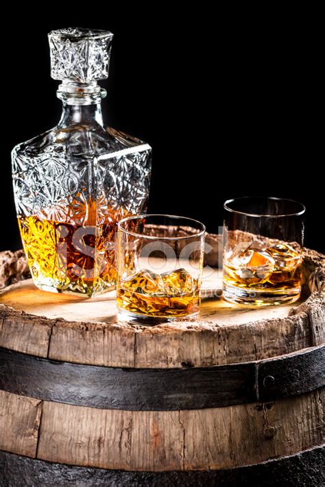 Two Glassed Of Aged Brandy Or Whiskey On The Rocks Stock Photo