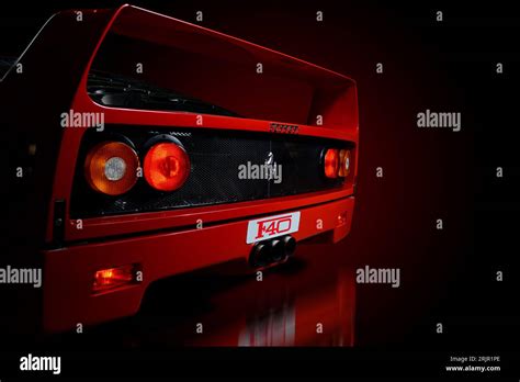 The Ferrari F40 rear end on a dark background and reflective surface ...