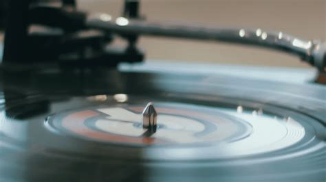 Close Up Of A Hand Which Changing Song On A Vinyl Record By Moving The