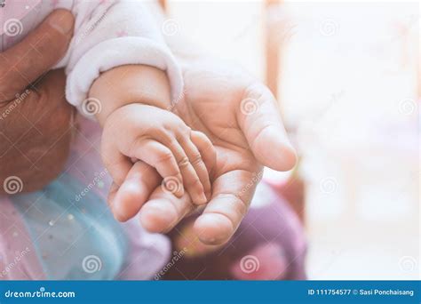 Asian Baby Girl Hand Holding Her Grandmother Hand With Love Stock Image