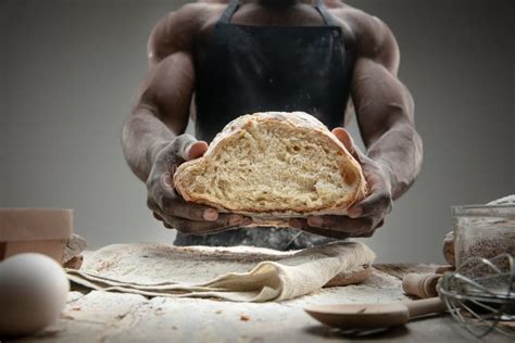 Close Up Of African American Man Cooks Bread At Craft Kitchen Stock