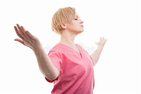 Attractive Female Nurse Wearing Pink Scrubs Making Winner Gesture Stock