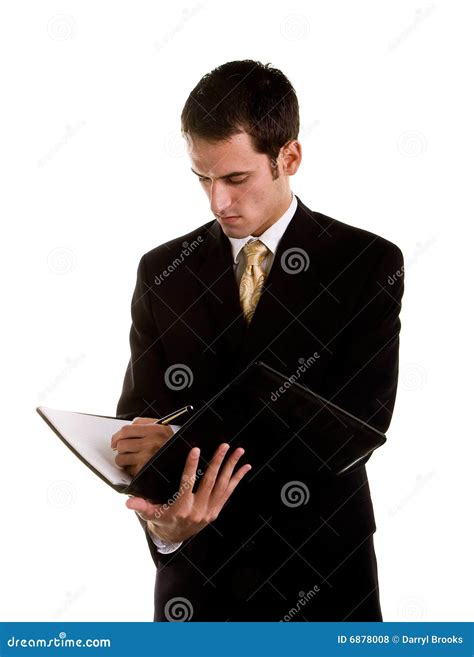 Young Businessman Writing In Notebook Looking Down Stock Photo Image