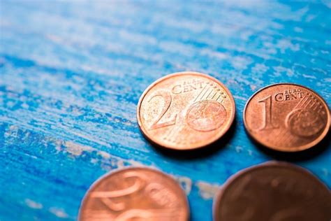 Premium Photo | Euro coins of different countries on blue background ...