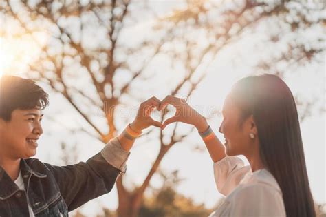 Happy Romantic Asian Lesbian Lgbt Couple Hand Making A Heart Sign With Lgbt Rainbow Flag