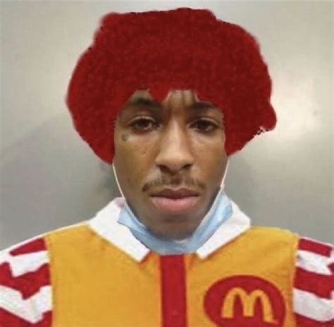 A Man With A Red Afro Wig On Top Of His Head Wearing A Mcdonalds Uniform