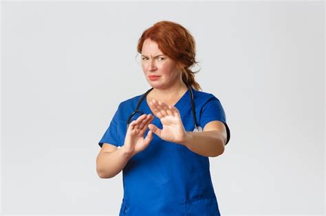 Premium Photo Reluctant And Displeased Redhead Female Doctor Asking