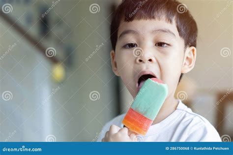 Adorable Baby Boy Holding In Hand Sherbet Ice Cream While Eat Happily