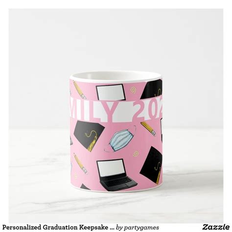 a pink coffee mug with graduation decorations on it