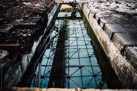 Sky And Rooftop Reflection In The Abandoned Factory Pool Del Colaborador De Stocksy Boris