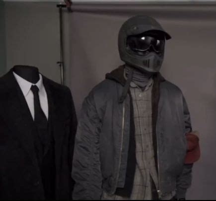 Two Mannequins Dressed In Suits And Helmets