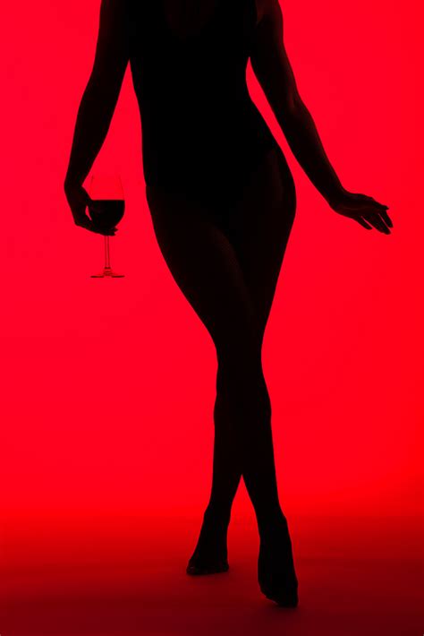 Cropped View Of Black Silhouette Of Sexy Woman Holding Glass Of