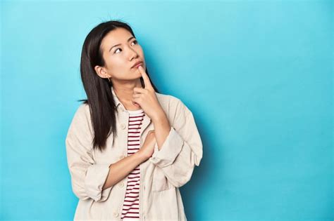 Premium Photo Asian Woman In Layered Shirt And Striped Tshirt Looking