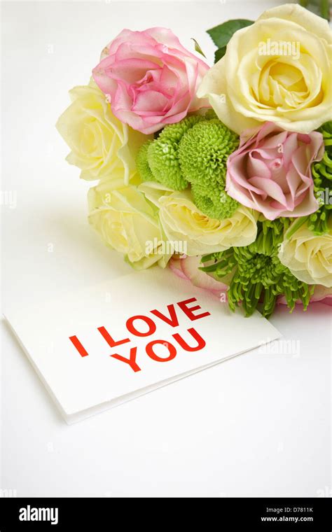 a bundle of flowers and a card saying I love you Stock Photo - Alamy