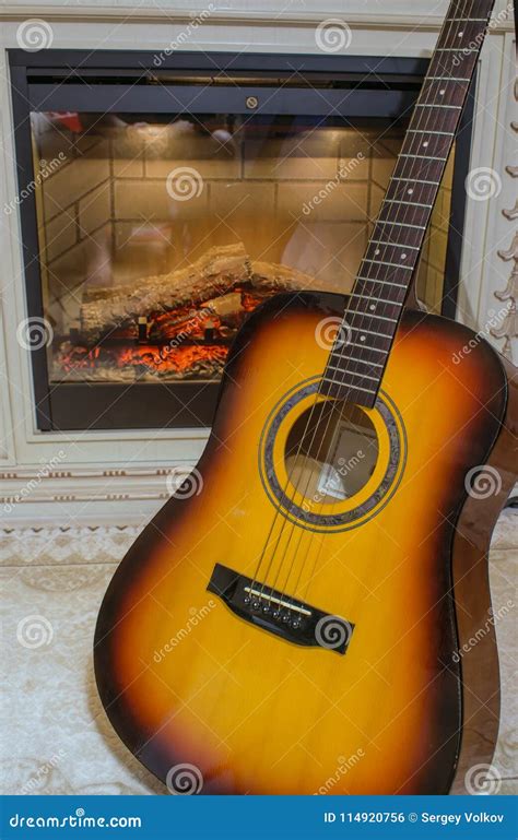 Six-string Guitar by the Burning Fireplace Stock Photo - Image of ...