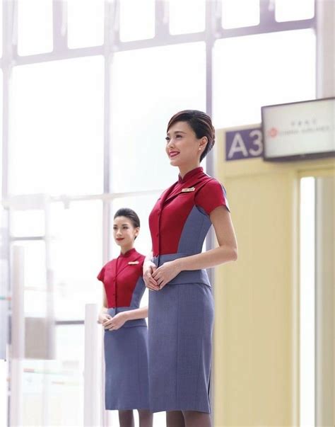 Two Air Hostess Standing Next To Each Other