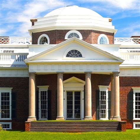 An Old Brick Building With Columns On The Front And Steps Leading Up To