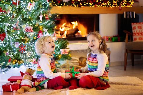 Child At Christmas Tree Kids At Fireplace On Xmas Stock Image Image