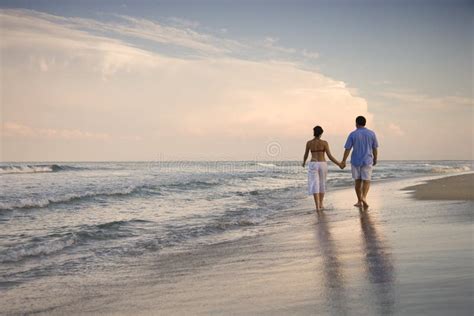 Couple Walking on Beach stock photo. Image of adults - 12666774