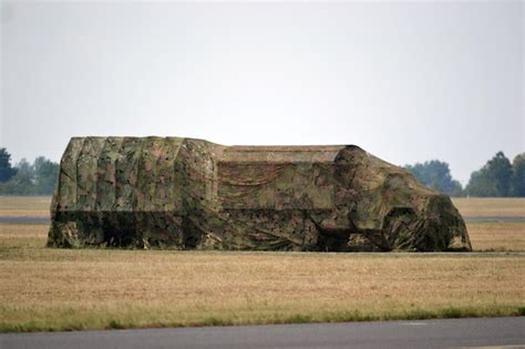 Premium Photo | Military truck with a trailer covered with camouflage net