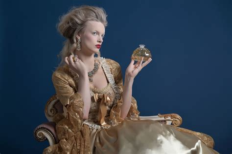 Retro Baroque Fashion Woman Wearing Gold Dress Holding Bottle O