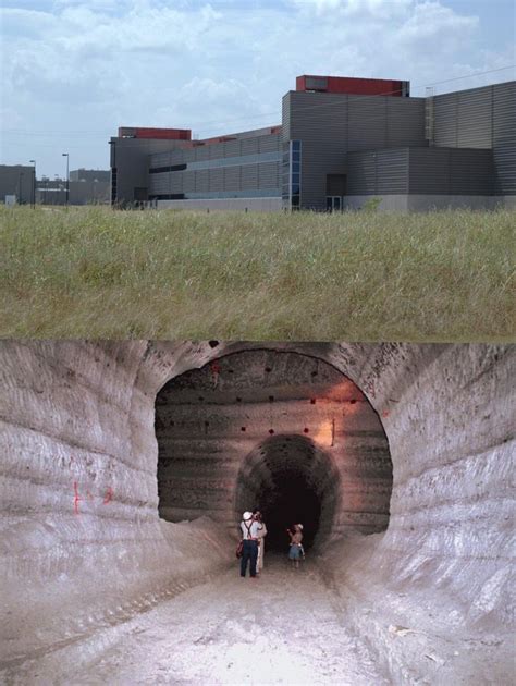 Two People Are Standing In The Middle Of A Large Pipe That Has Been Dug