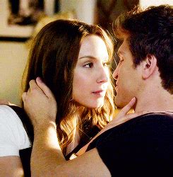 a man kissing a woman on the cheek